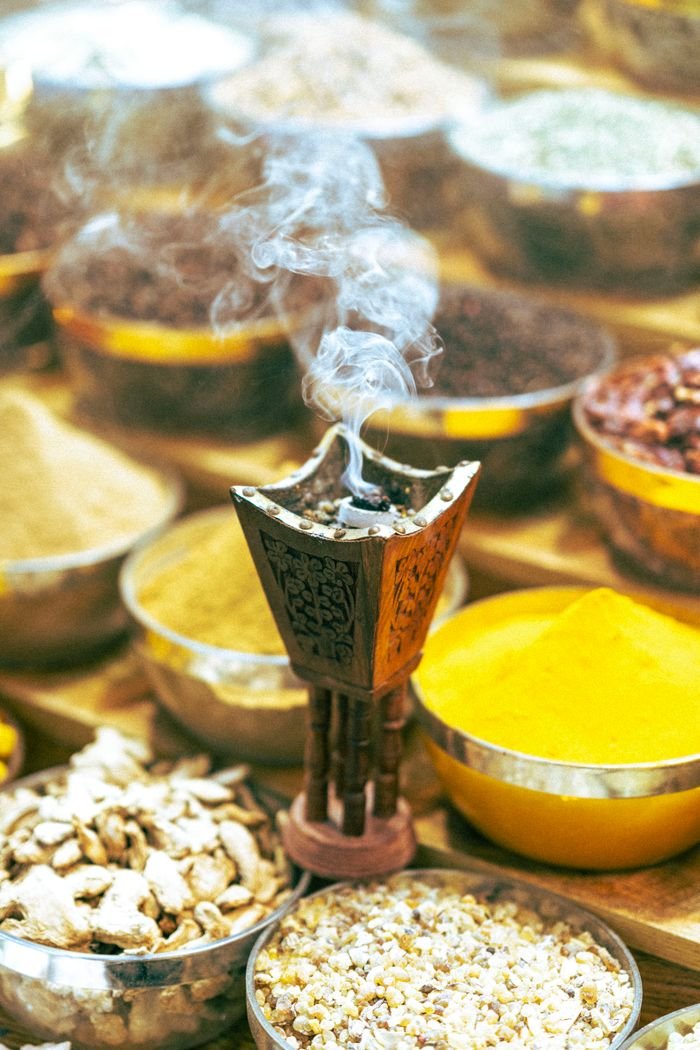 Boswellia Neglecta: Ethiopian Frankincense, Composition, Origin and Uses Colorful spices and incense burner with smoke in a traditional Dubai market setting.